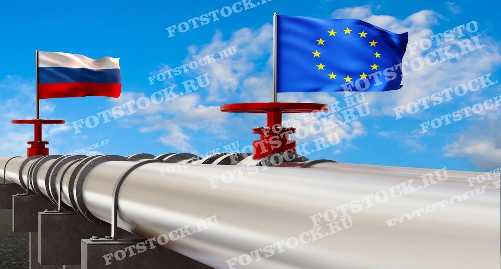 На фото изображен трубопровод с флагами России и Европейского Союза на фоне голубого неба. Это символизирует энергетическое сотрудничество и взаимозависимость между Россией и странами ЕС в сфере поставок нефти и газа.